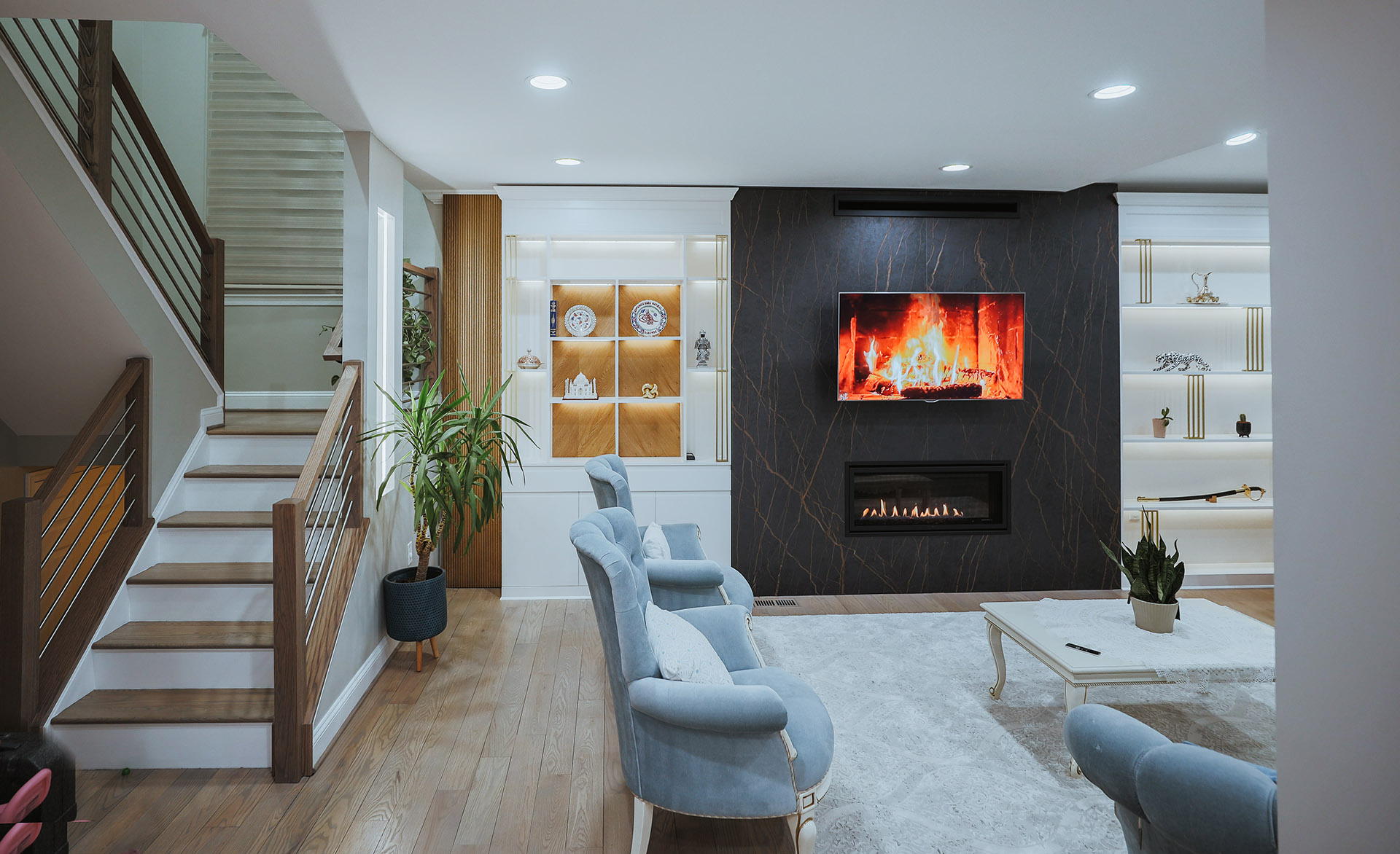 Basement remodeling in Northern Virginia creating a cozy living area with a modern fireplace, built-in shelving, and custom lighting that adds comfortable and functional square footage in the DC area.