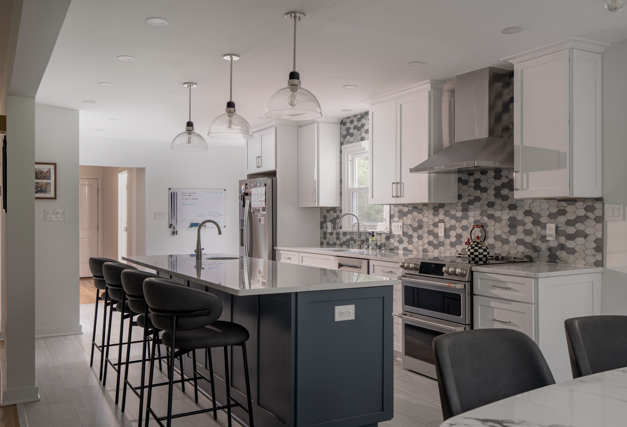 open concept kitchen remodel with blue island quartz countertops and bar seating