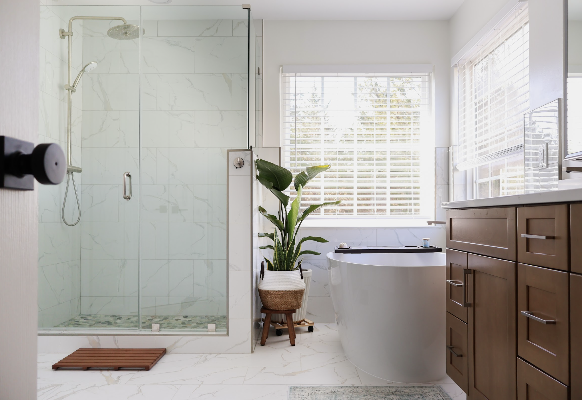 Chantilly VA bathroom remodel with double sink vanity, custom wood cabinetry, quartz countertop, and frameless shower