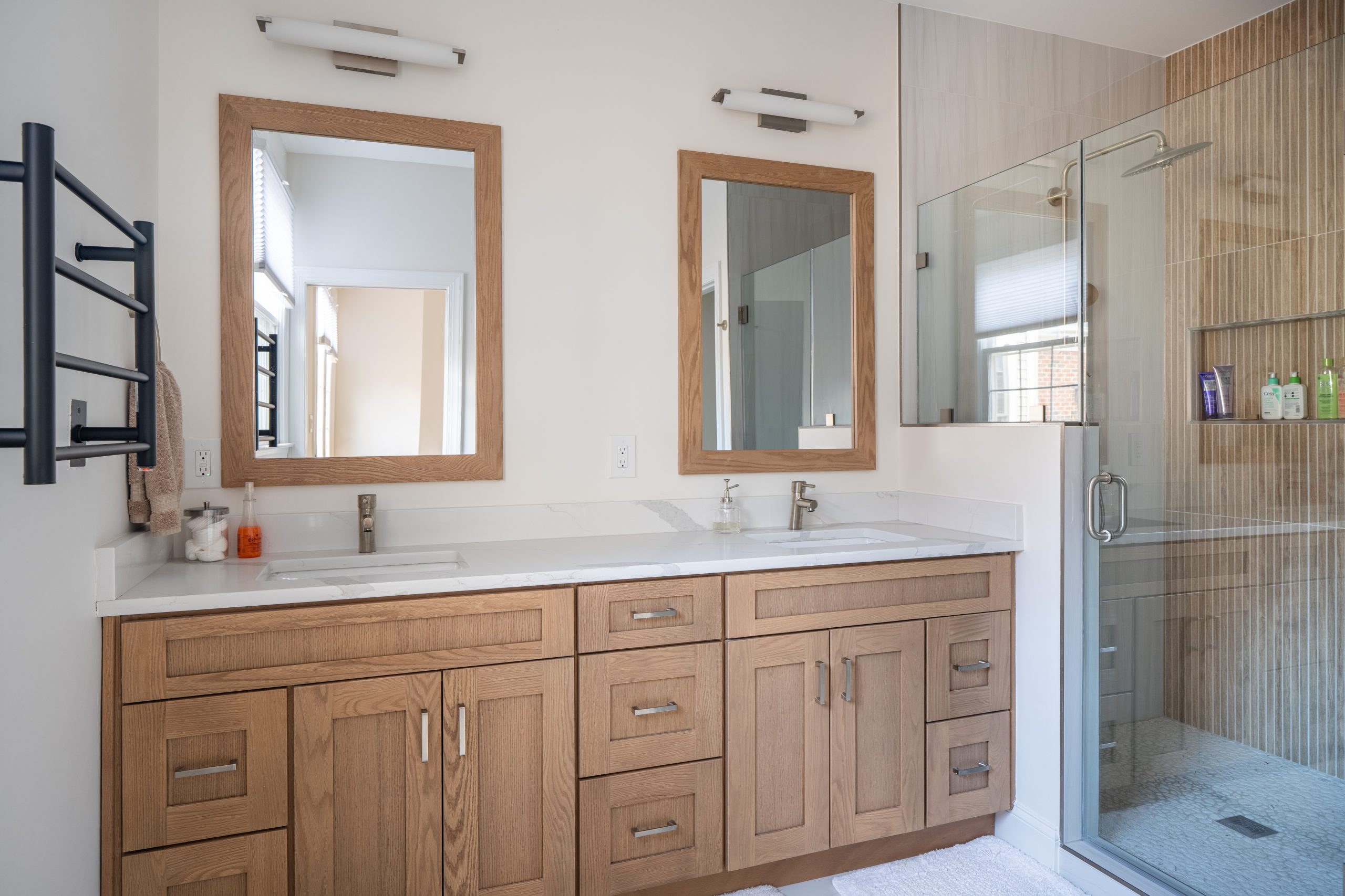 Chantilly VA luxury bathroom remodel with freestanding soaking tub, frameless glass shower, and marble tile