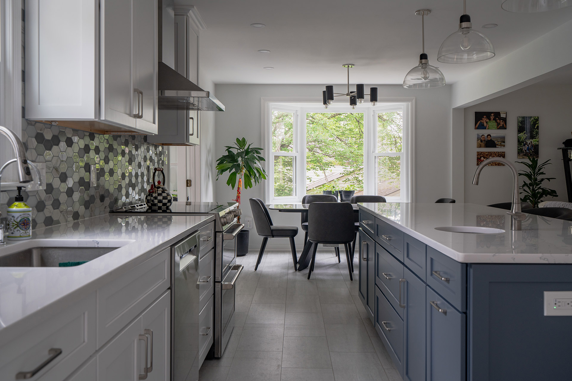 Small kitchen renovation in Vienna, VA with a blue island, hexagon tile backsplash, and a bay window dining nook.