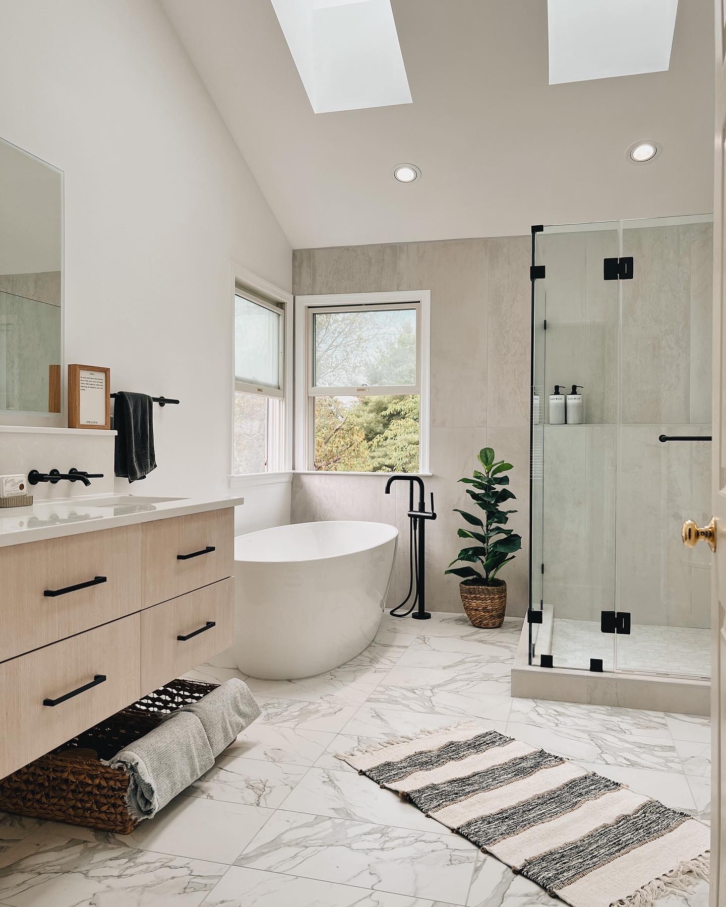 Frameless glass shower with large-format tile in a modern bathroom