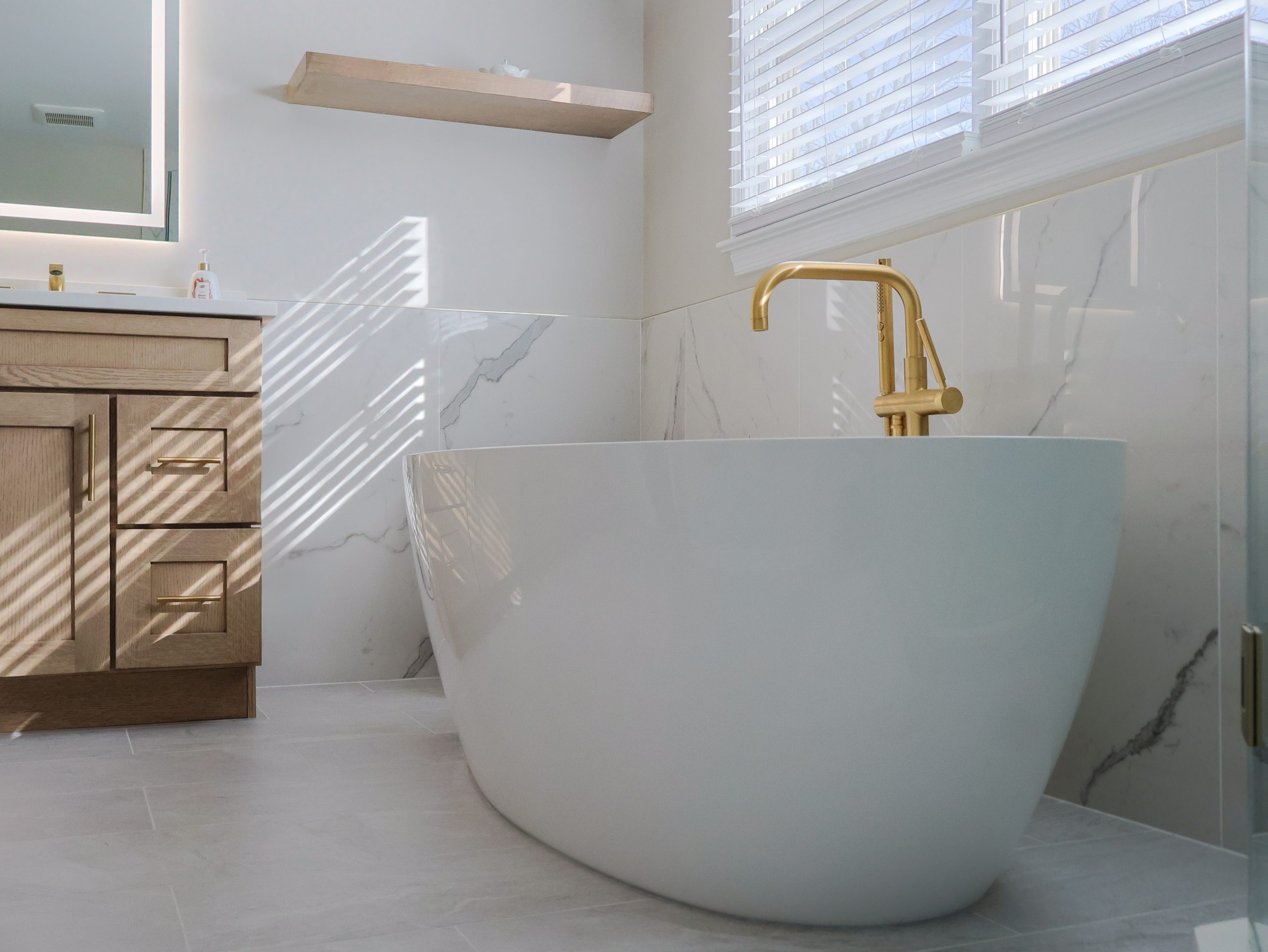 Modern bathroom with freestanding bathtub and white tile