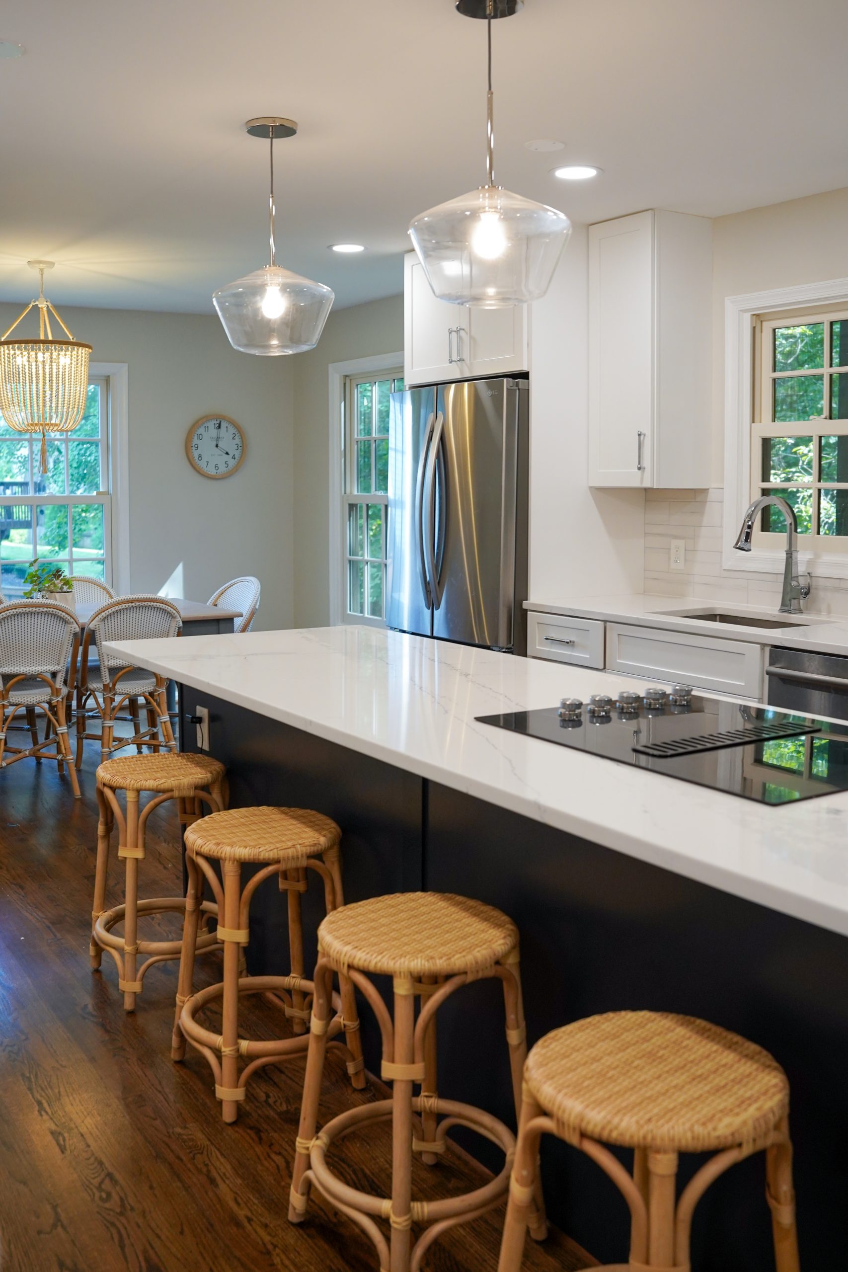 Modern kitchen with wood cabinets, island, and quartz countertops