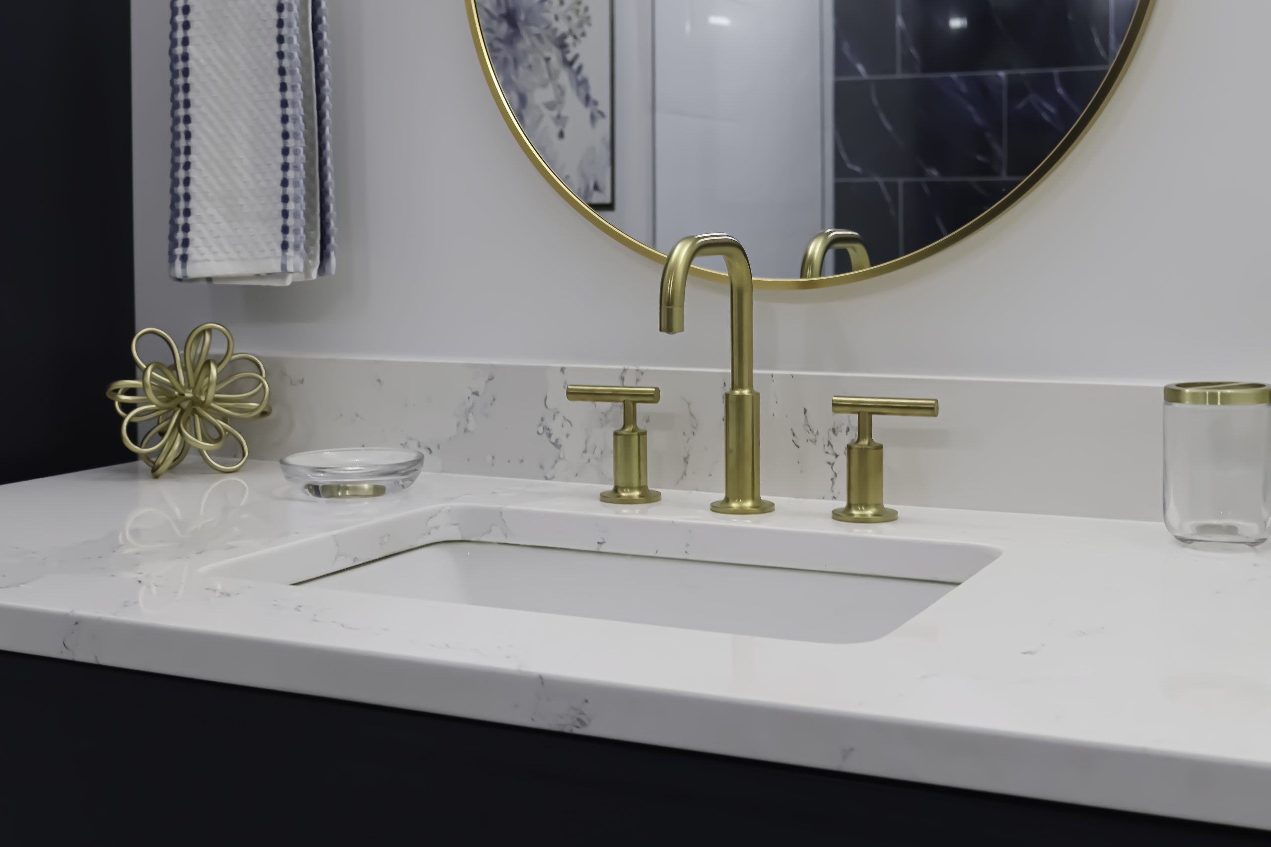 White bathroom vanity with vessel sink and brass faucet